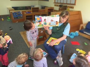 Meadowlake Day School teacher reading a story to children